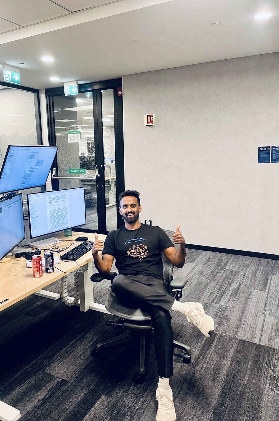 Arghya Ghosh at his desk, giving a thumbs up.